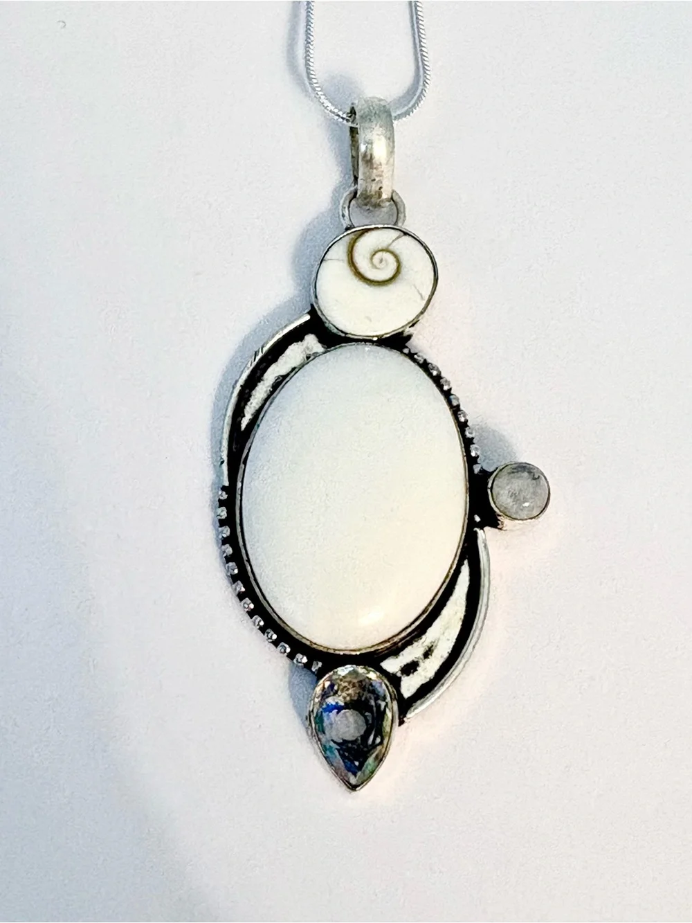 White Opal, Shiva Eye, Mystic Topaz and Moonstone pendant on silver chain.